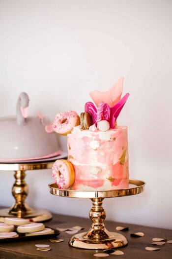 Gold cake stand with pink cake event hire