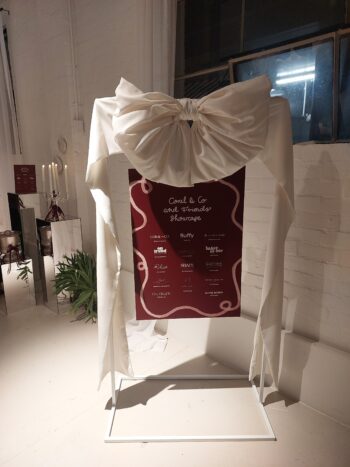 White big bow on a white Signage Stand. On Trend Event Hire