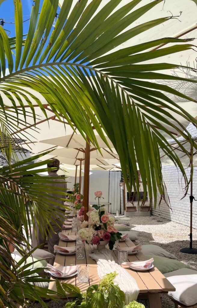 Outdoor white market umbrellas for hire Melbourne and scalloped blush napkins with beige table runners and cushions